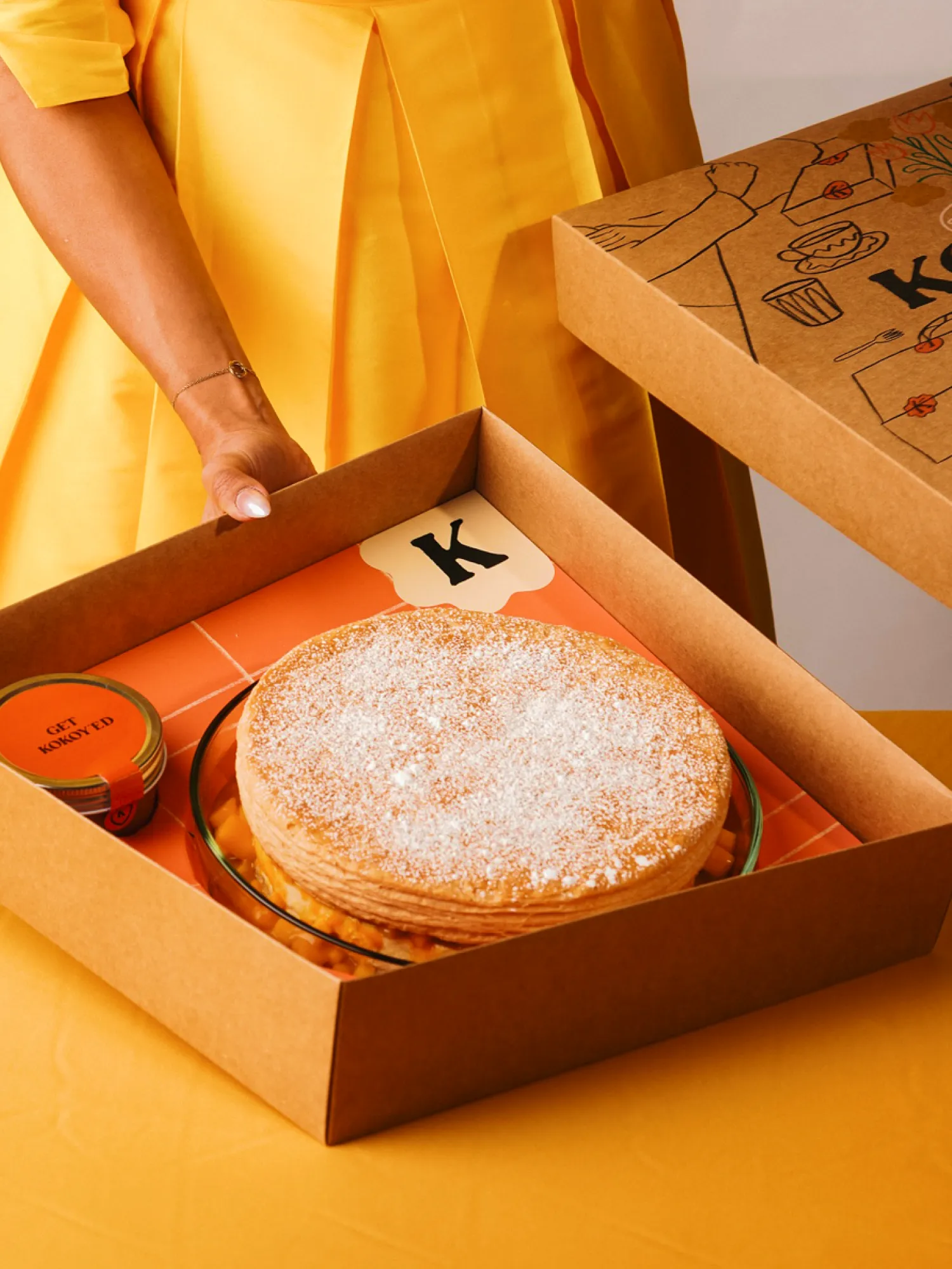 Kokoy dessert and cream in an open presentation box.