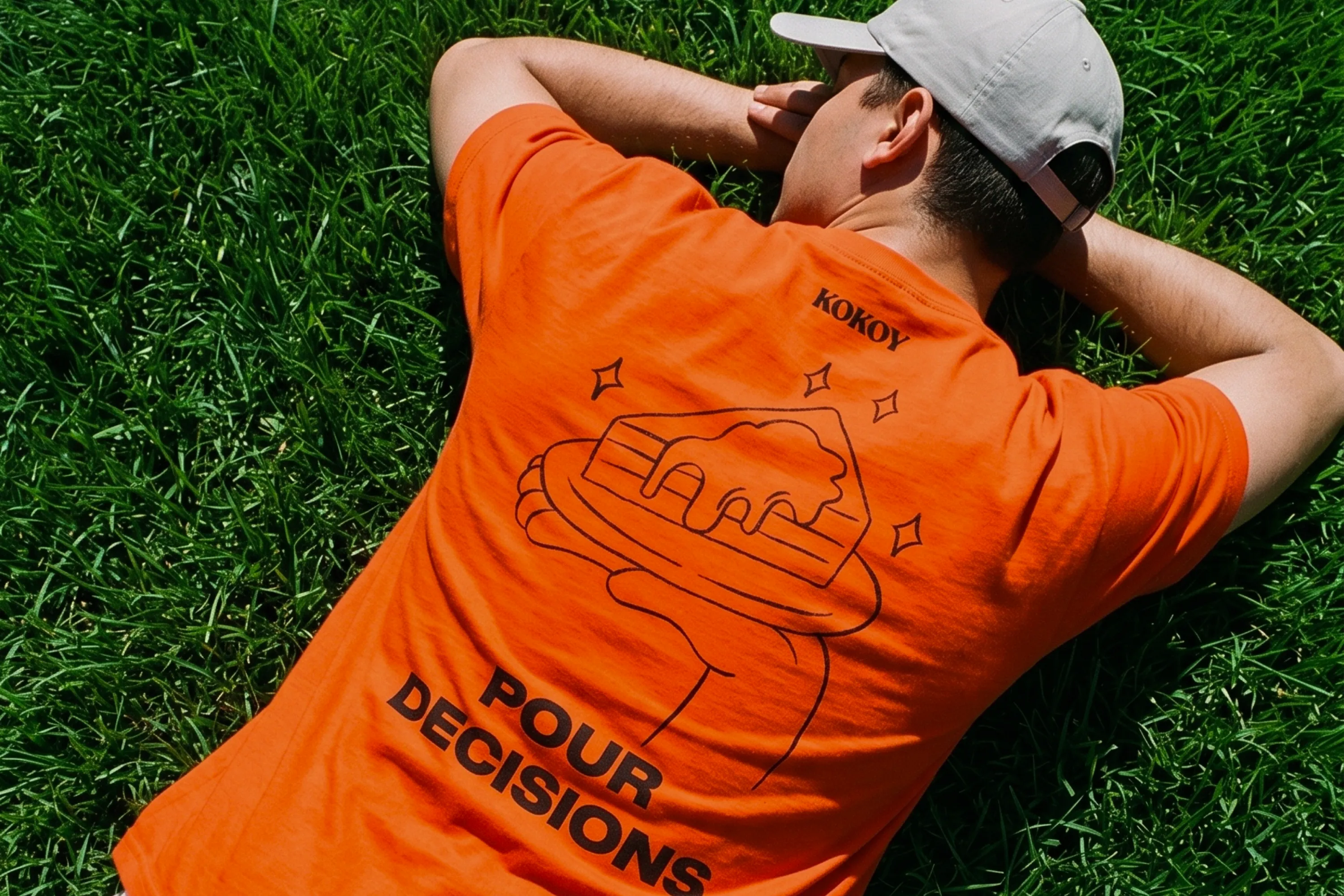 Orange Kokoy shirt with Pour decisions graphics.