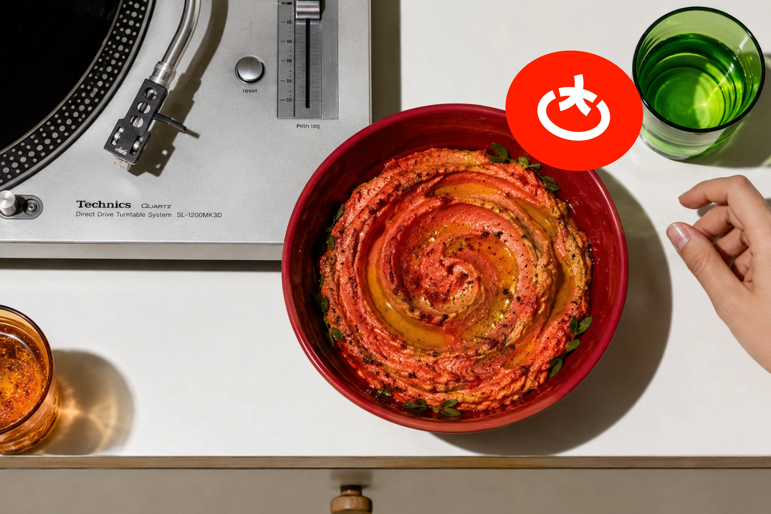 Pasta, tomato paste, and a record player on a dining table.