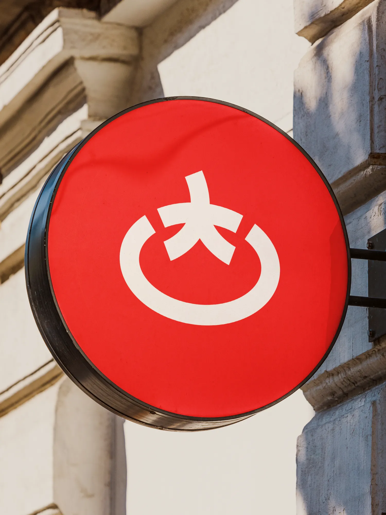 Circular red Toomato storefront sign.
